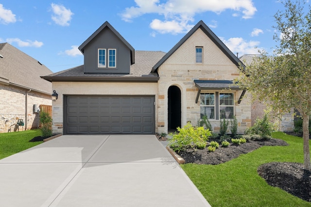 view of front of home featuring a garage and a front lawn