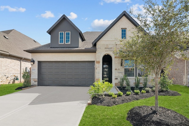 view of front of property featuring a garage and a front yard