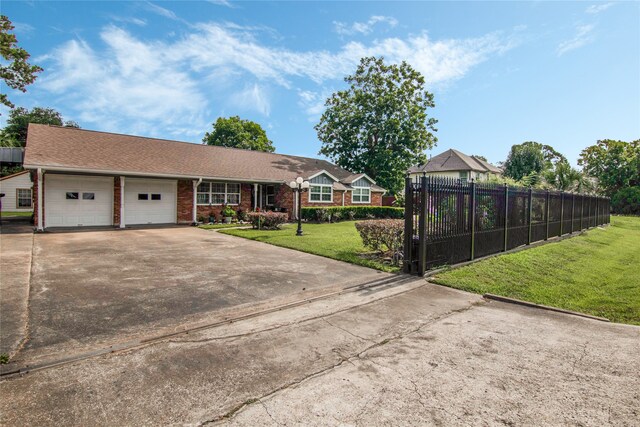 single story home featuring a garage and a front yard