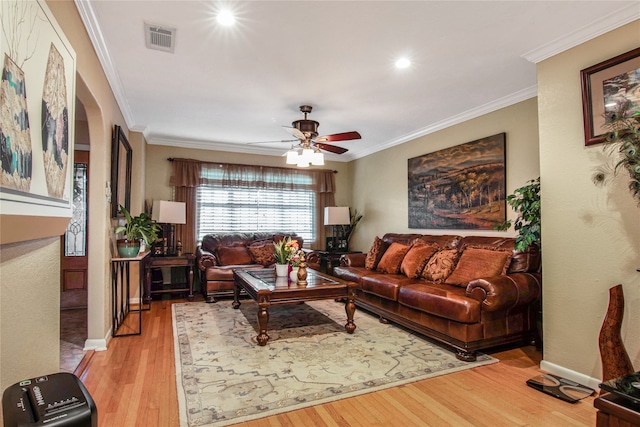 living room with ornamental molding, ceiling fan, and hardwood / wood-style floors