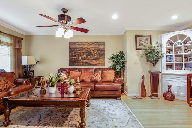 living room with hardwood / wood-style floors, ornamental molding, and ceiling fan