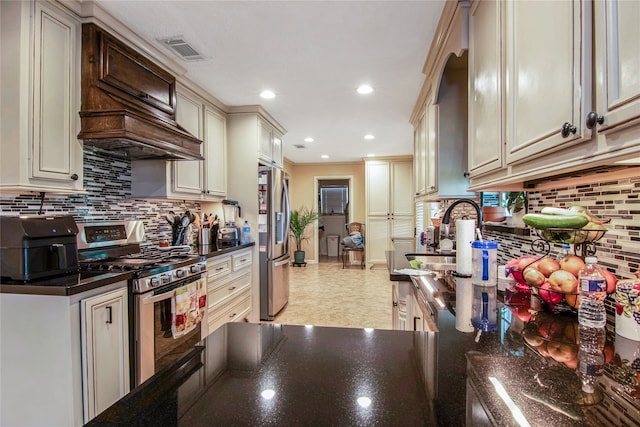 kitchen with stainless steel appliances, custom exhaust hood, tasteful backsplash, and cream cabinets