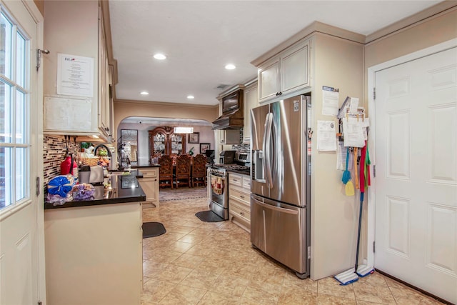 kitchen featuring a healthy amount of sunlight, tasteful backsplash, light tile floors, and stainless steel appliances