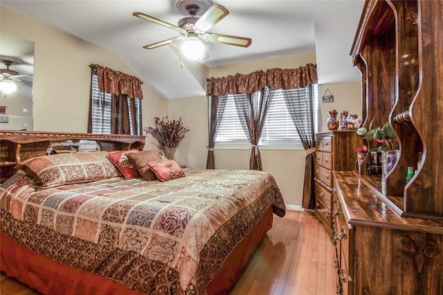 bedroom featuring ceiling fan, vaulted ceiling, and wood-type flooring