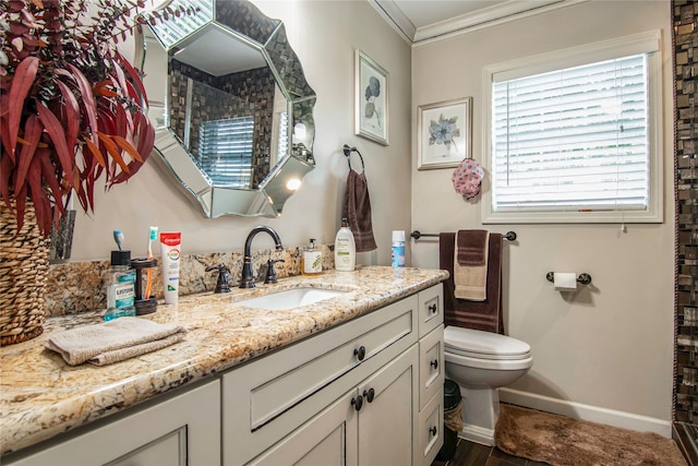 bathroom featuring vanity, toilet, and ornamental molding