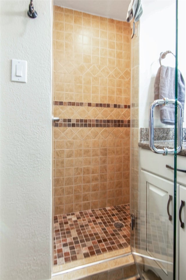 bathroom with a shower with shower door