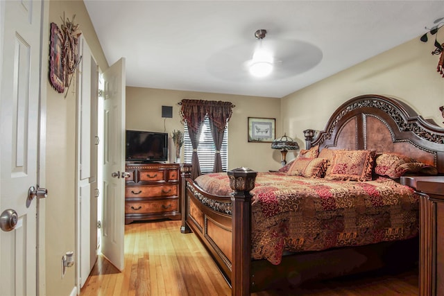 bedroom with ceiling fan and light wood-type flooring