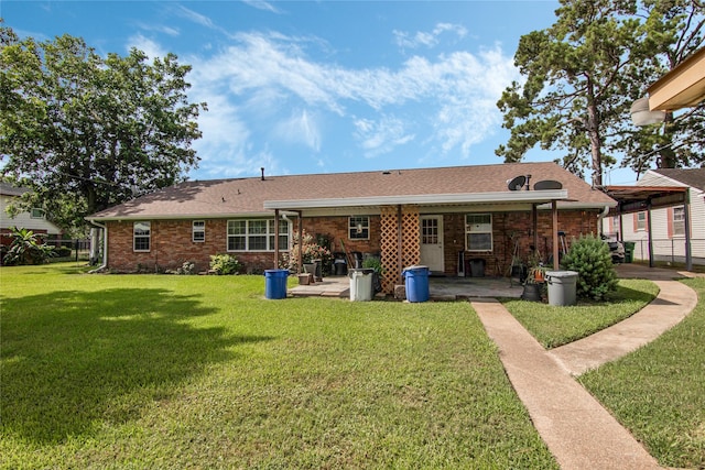 rear view of house featuring a lawn and a patio area