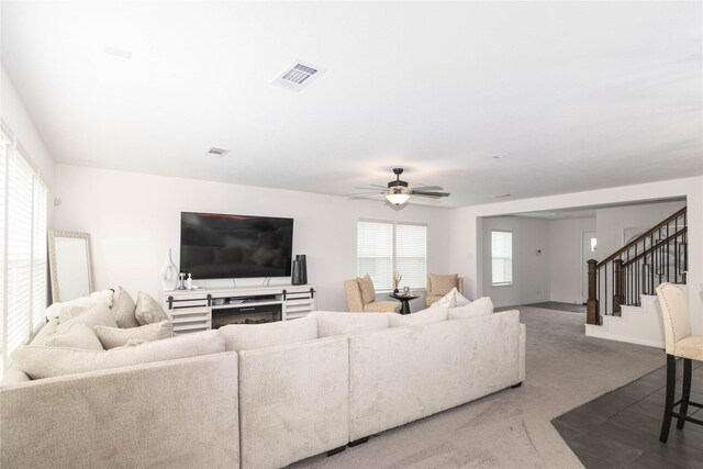 living room with carpet and ceiling fan