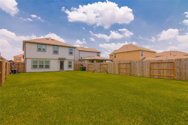 back of house with a yard