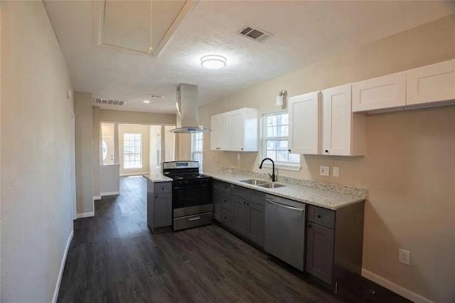 kitchen featuring dark wood-type flooring, gray cabinetry, stove, and stainless steel dishwasher