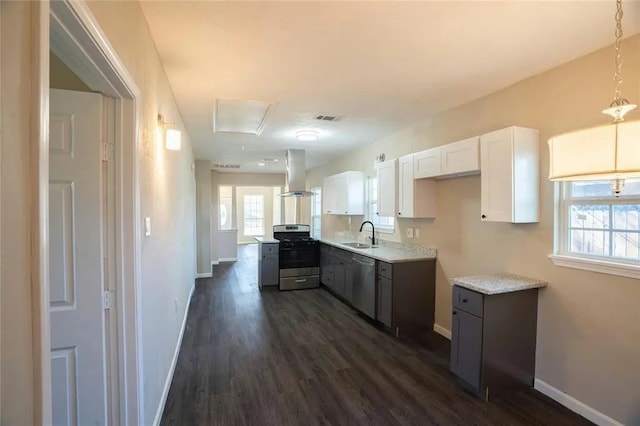 kitchen with white cabinetry, appliances with stainless steel finishes, plenty of natural light, and island range hood