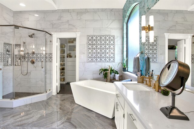 bathroom featuring vanity, tile walls, and independent shower and bath