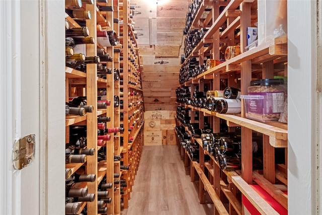 wine cellar with wooden walls and hardwood / wood-style floors