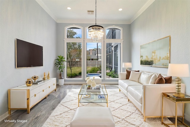 living room featuring crown molding, plenty of natural light, and wood-type flooring