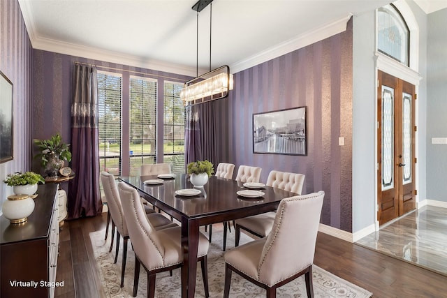 dining room featuring crown molding, dark wood-type flooring, and a notable chandelier