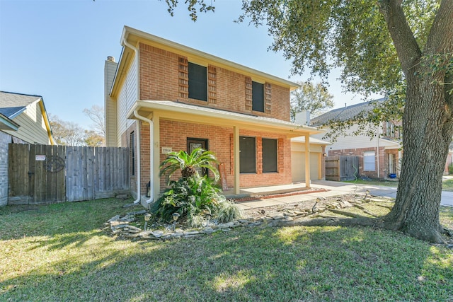 back of house featuring a garage and a lawn