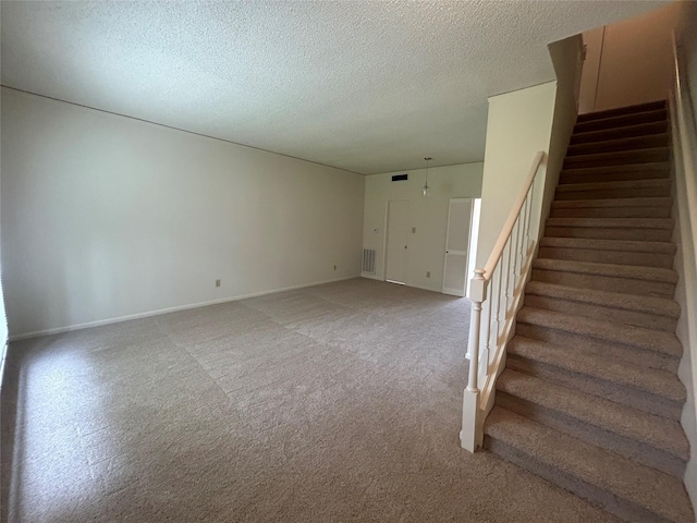 interior space with carpet and a textured ceiling