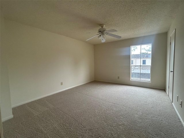 carpeted empty room with ceiling fan and a textured ceiling