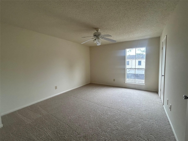 carpeted spare room with ceiling fan and a textured ceiling