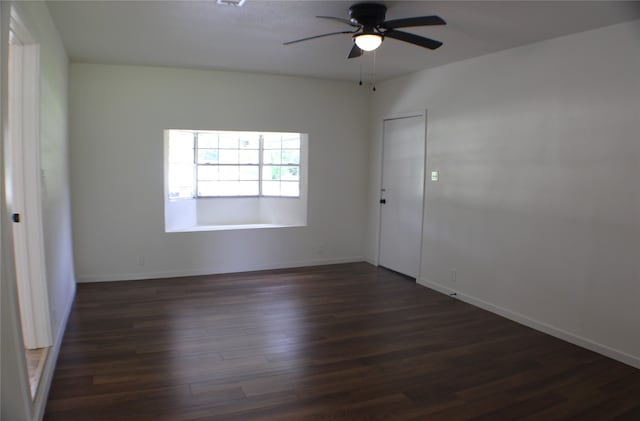 spare room with ceiling fan and dark hardwood / wood-style flooring