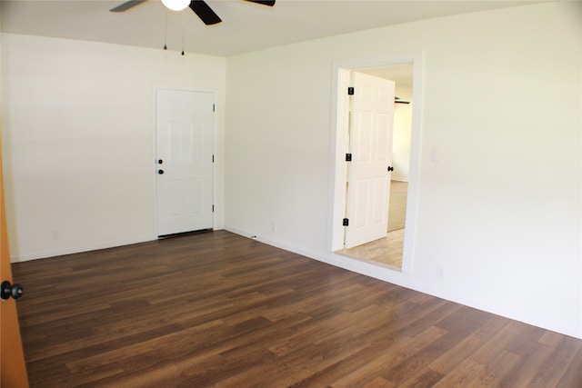 empty room featuring dark hardwood / wood-style flooring and ceiling fan