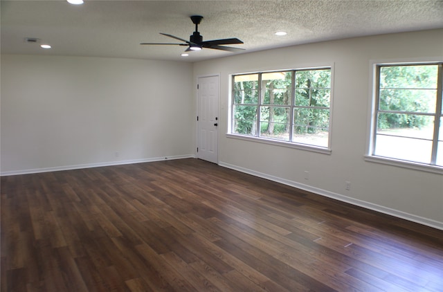 spare room with a textured ceiling, dark hardwood / wood-style floors, and ceiling fan