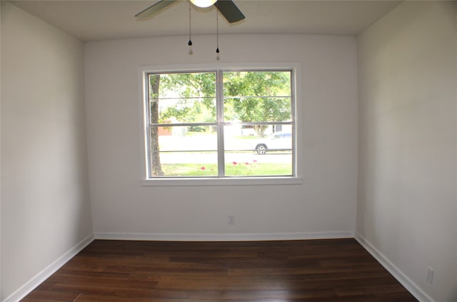 empty room with ceiling fan and dark hardwood / wood-style floors