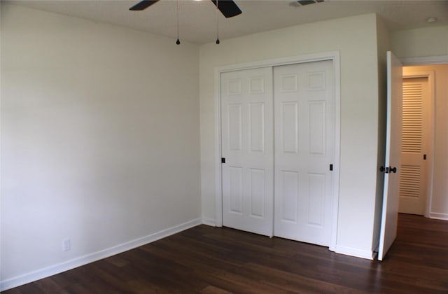 unfurnished bedroom featuring dark hardwood / wood-style flooring, a closet, and ceiling fan