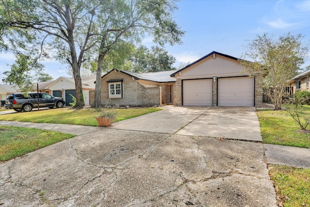 single story home with a front lawn and a garage