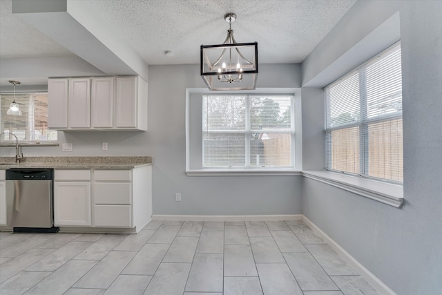 unfurnished dining area featuring a notable chandelier, a textured ceiling, a healthy amount of sunlight, and light tile patterned floors