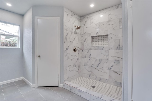 bathroom featuring tiled shower and tile patterned floors