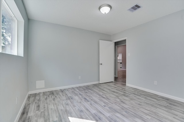 unfurnished room featuring light wood-type flooring