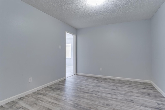 6218 Sunnygate Dr, Spring, TX 77373 - spare room with baseboards, a textured ceiling, and wood finished floors