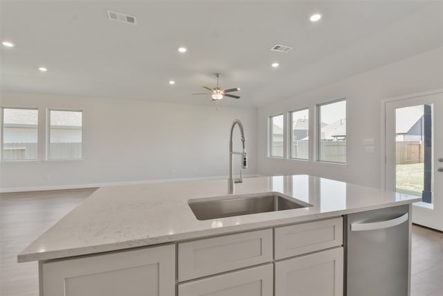 kitchen featuring dishwasher, light hardwood / wood-style flooring, plenty of natural light, and sink