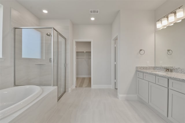 bathroom featuring vanity and plus walk in shower