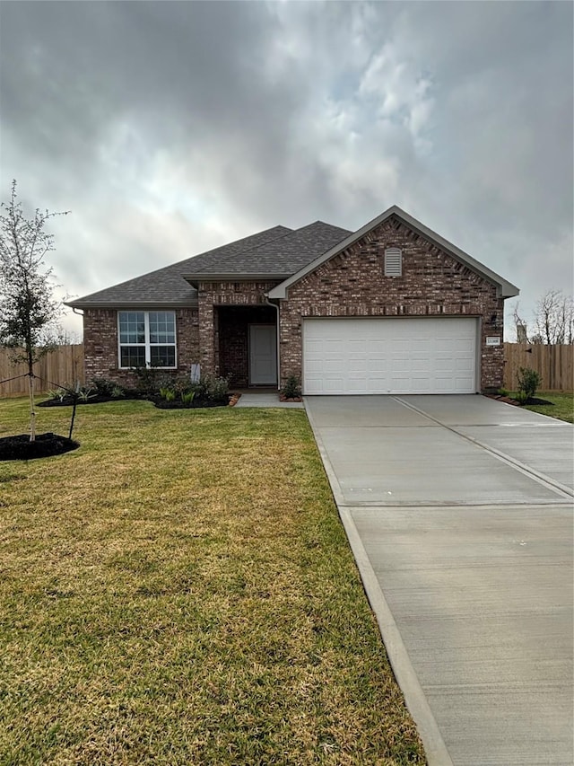 ranch-style home featuring a front yard and a garage