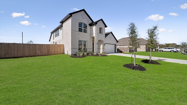 french country inspired facade with a front yard and a garage