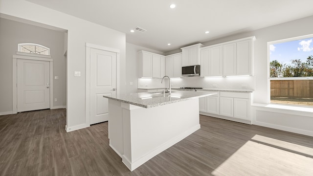 kitchen with white cabinets, dark wood-type flooring, and sink