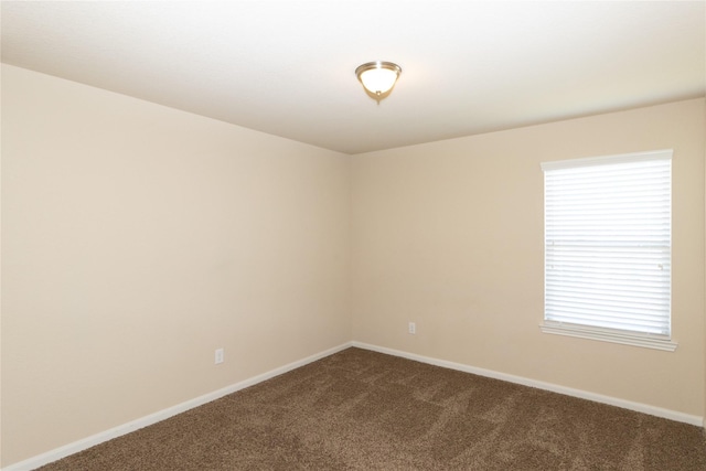 carpeted spare room with a healthy amount of sunlight