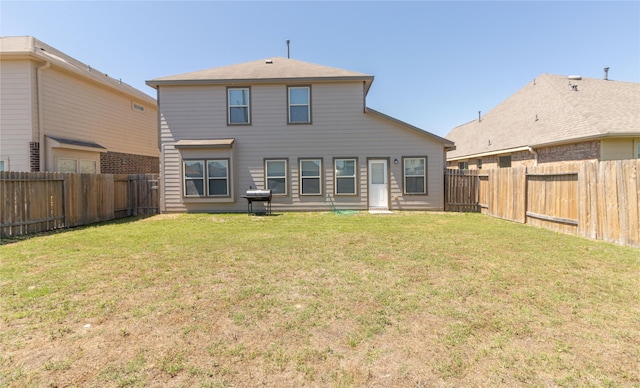 rear view of house with a lawn