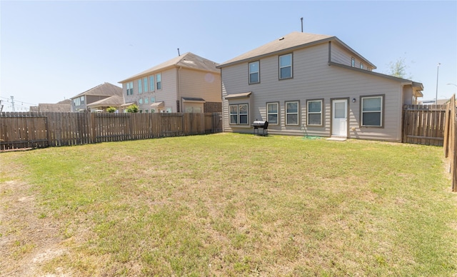 rear view of property featuring a lawn