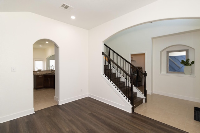 entryway with tile patterned flooring and sink