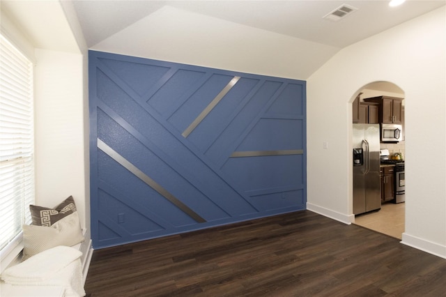 interior space featuring lofted ceiling and dark hardwood / wood-style floors