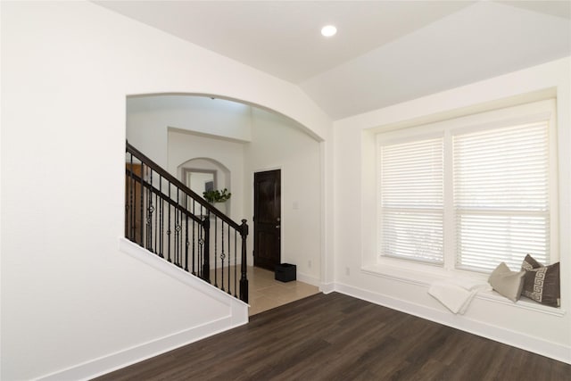 interior space featuring dark hardwood / wood-style flooring and vaulted ceiling