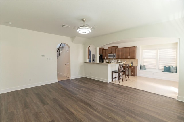 unfurnished living room with dark hardwood / wood-style flooring