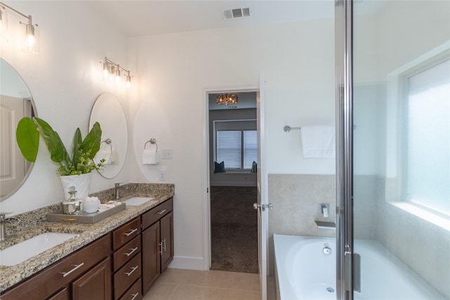 bathroom featuring tile patterned flooring, separate shower and tub, and vanity