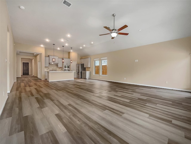 unfurnished living room with hardwood / wood-style floors and ceiling fan