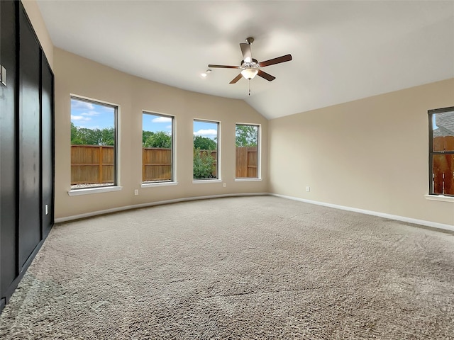 spare room featuring ceiling fan, carpet floors, and lofted ceiling