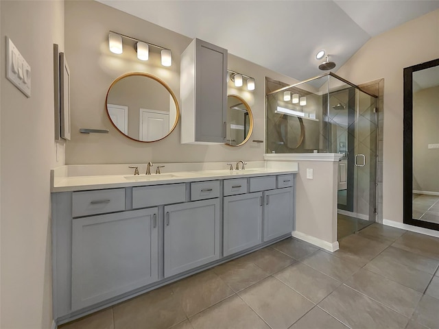 bathroom featuring tile patterned flooring, vanity, vaulted ceiling, and walk in shower